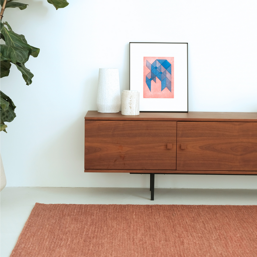 Terracotta tapijt gecombineerd met meubels in een woonkamer.ALT